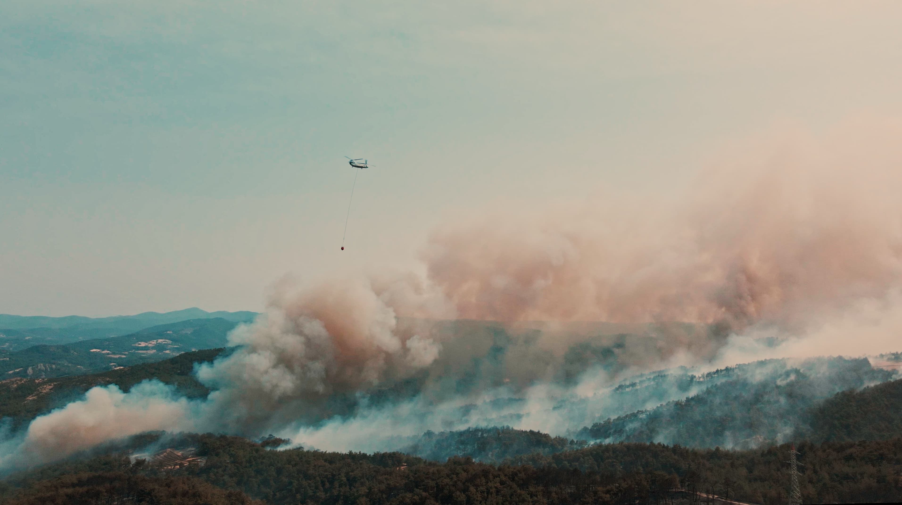 Wildfire smoke over forested mountains